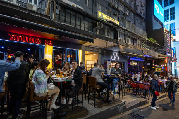 Hong Kong - December 12, 2024 : People at bars in the Lan Kwai Fong area in Hong Kong.